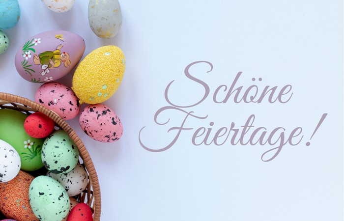 Grafik mit Ostergrüßen und bunten Eiern.