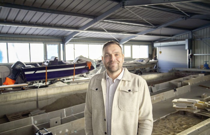 Foto des Absolventen Kevin Stauch in einer Lagerhalle für Wasserfahrzeuge.