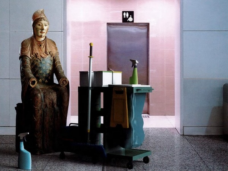 Illustration of a historical statue with cleaning products in a modern building.